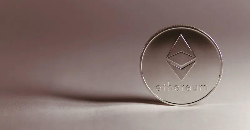 Close-up of a silver Ethereum coin symbolizing digital currency and blockchain technology.