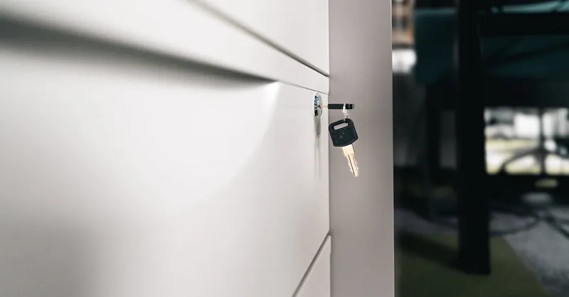 Close-up of a key in a locked office drawer for secure storage and privacy.