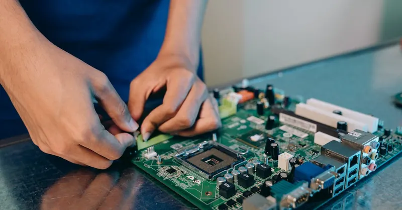 Hands-on assembly of a computer motherboard with precision tools.