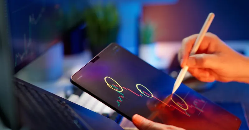 Person analyzing cryptocurrency trends on a tablet with digital pen.