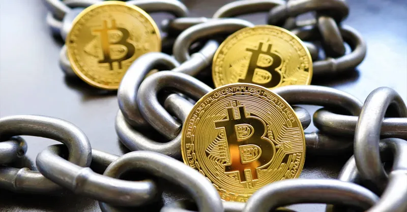 Close-up of Bitcoin coins entwined in metallic chains showcasing cryptocurrency security.